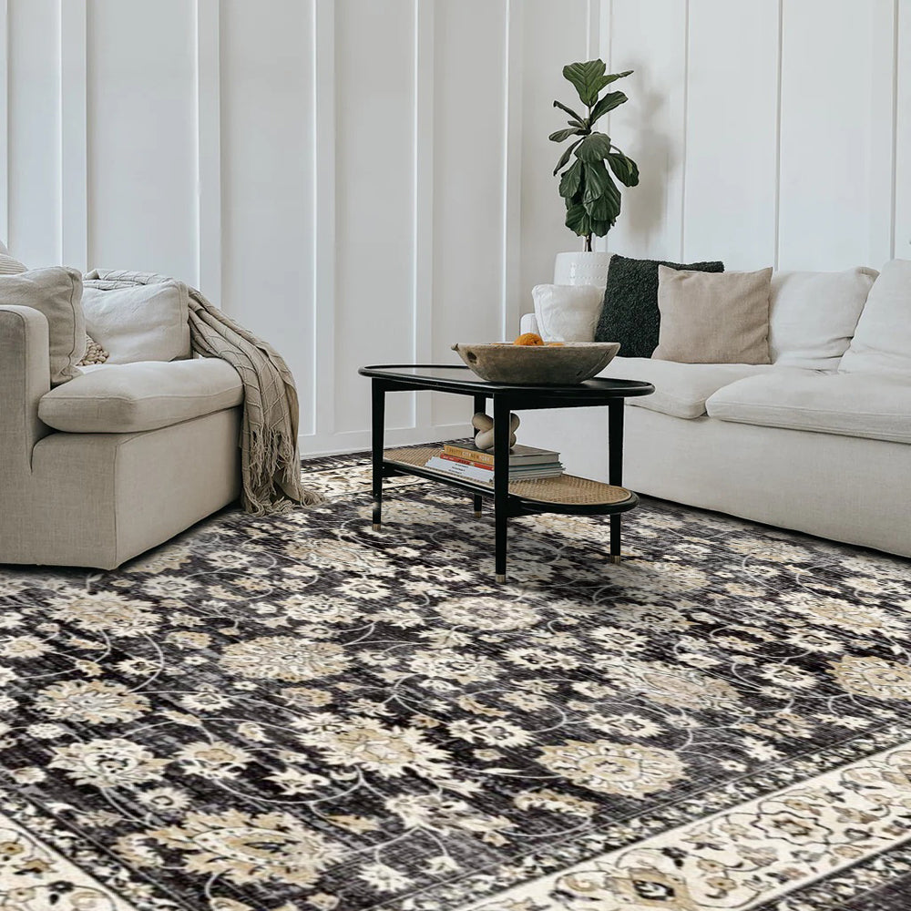 Eowyn vintage washable area rug in a living room, black floral design, power loomed polyester.