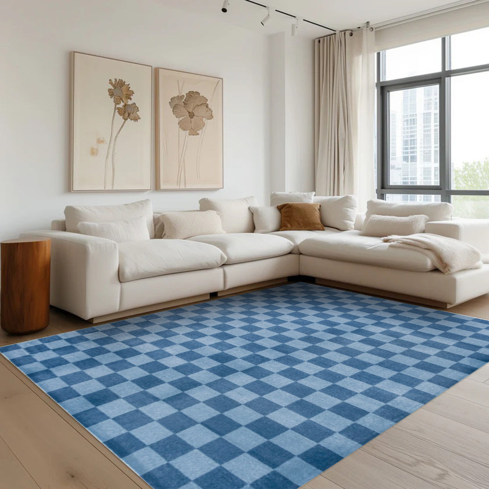 Blue checkered Tiberius washable area rug in a modern living room setting.