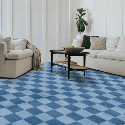 Blue checkered Tiberius washable area rug in a modern living room setting, showcasing modern living room furniture.