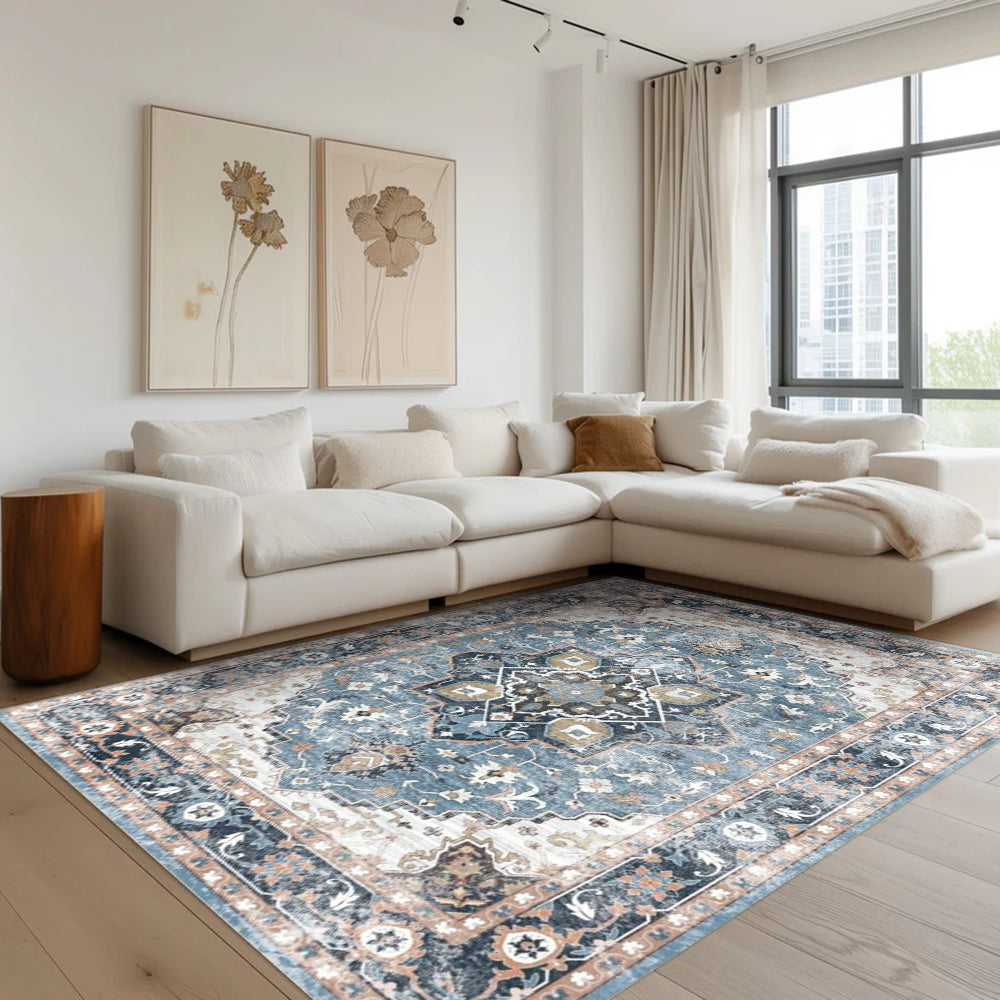 Astraea Vintage Washable Rug in a living room setting, featuring a blue and cream vintage pattern.