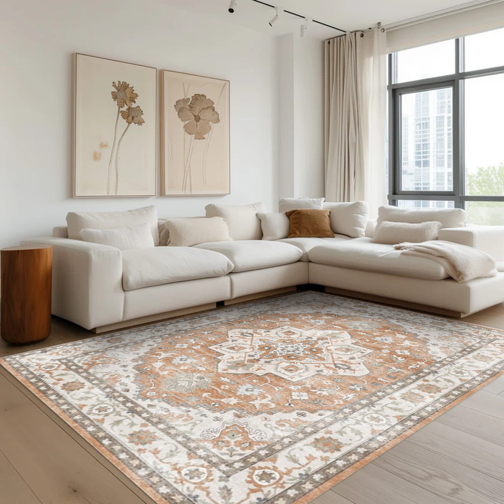 Caledon Vintage Washable Rug, orange & ivory tones, intricate patterns, in a modern living room setting. Washable area rug.
