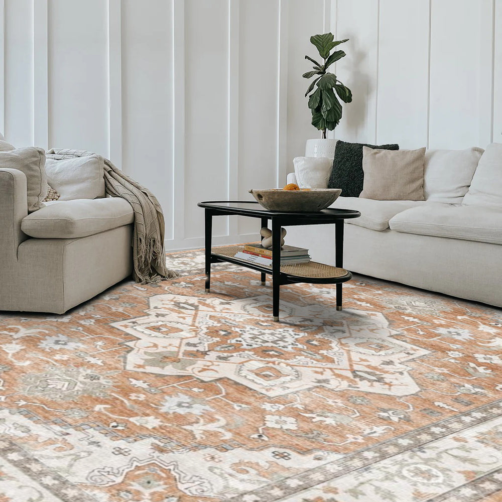 Caledon Vintage Washable Rug, orange and ivory geometric pattern, modern living room setting. Machine washable.
