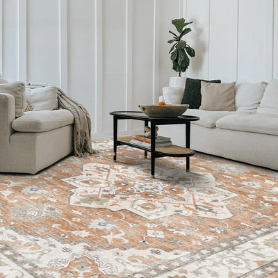 Caledon Vintage Washable Rug, orange and ivory geometric pattern, modern living room setting. Machine washable.