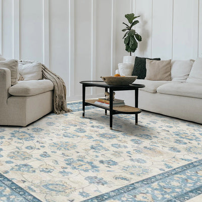Eleutheria Vintage Washable Rug in a living room setting, blue floral design, washable area rug.
