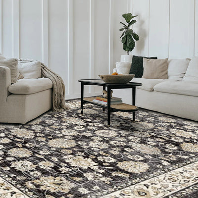 Eowyn vintage washable area rug in a living room, black floral design, power loomed polyester.