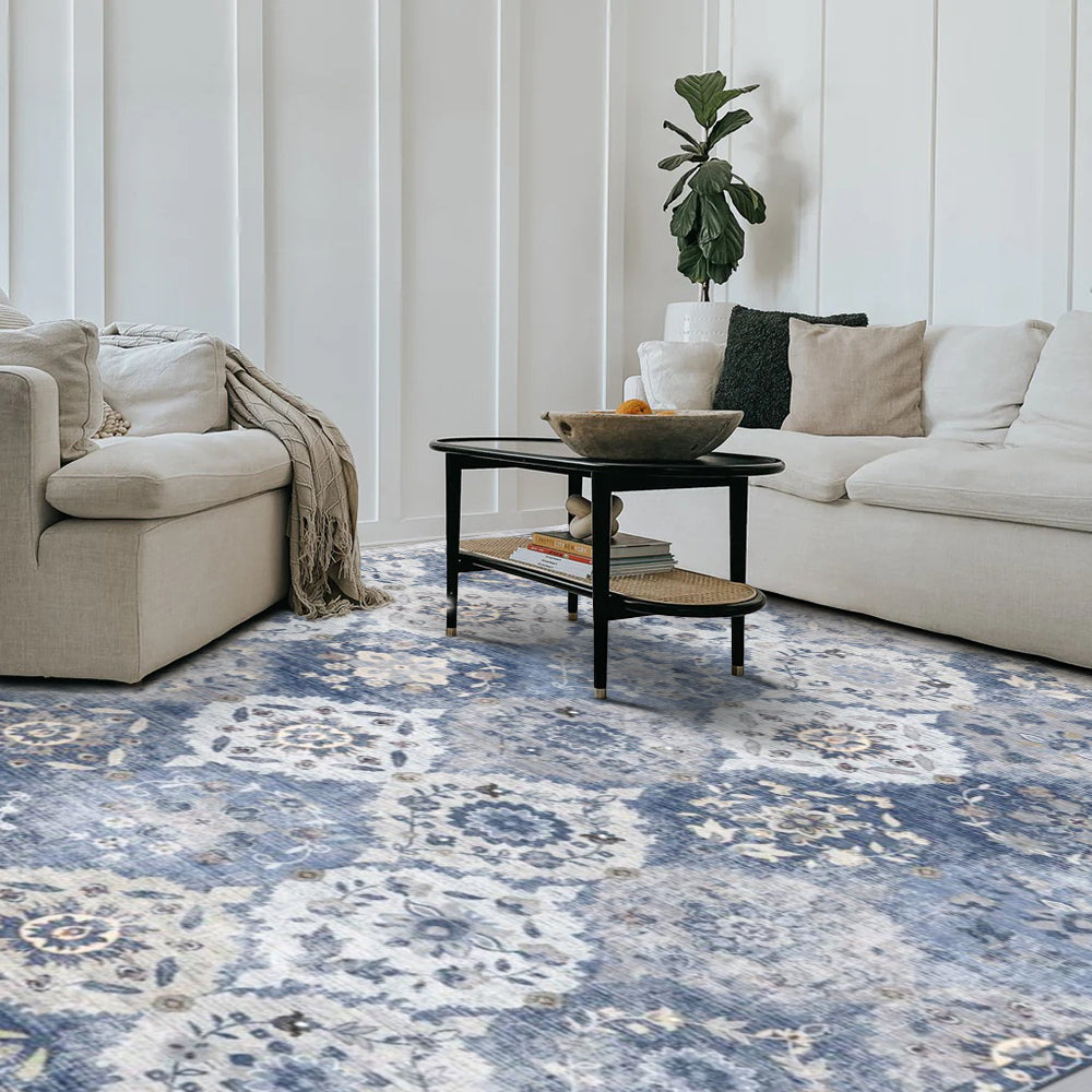 Marine Persian washable rug in blue and cream floral pattern, showcased in a modern living room setting.