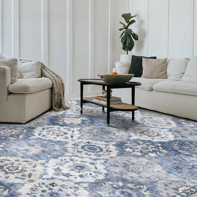Marine Persian washable rug in blue and cream floral pattern, showcased in a modern living room setting.