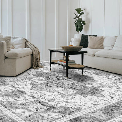 Onyx Persian washable rug in a living room setting, showcasing a gray and white medallion design, made of 100% polyester.